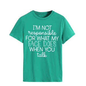 Detail of green cotton T-shirt featuring white slogan print and neat sleeve stitching