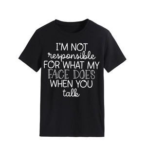 Detailed close-up of white letter print on a black crew neck cotton t-shirt