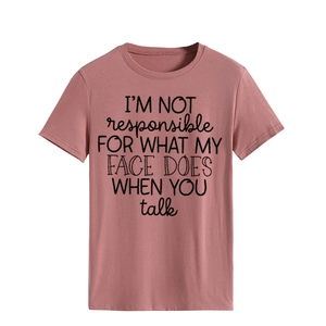 Close-up of pink crewneck t-shirt fabric with black 'I'M NOT responsible' slogan print