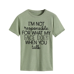 Close-up of cotton blend t-shirt fabric and black slogan print on green background