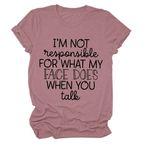 Close-up of pink crew neck T-shirt featuring 'I'M NOT responsible' slogan print