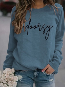 Detail of blue crewneck sweatshirt with Indoorsy script print and soft knitted texture