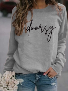 Close-up of ribbed crew neck and black Indoorsy letter print on grey casual sweatshirt