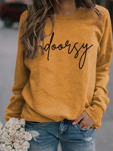 Detail of ginger yellow crewneck sweatshirt with black Indoorsy script print and soft fabric