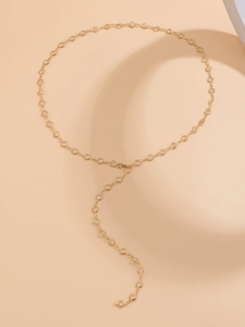 Detailed view of elegant gold Y-shaped body chain with shimmering crystal accents
