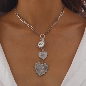 Silver multilayer necklace with sun eye and heart charms on paperclip chain
