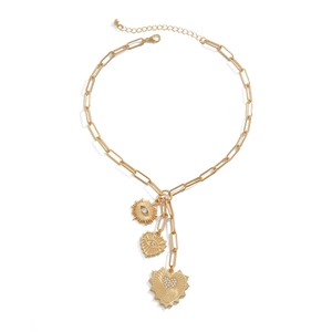 Golden paperclip chain necklace with heart and zircon sun eye pendants on white backdrop