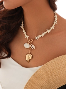 Close-up of Bohemian ocean necklace with shell charms, starfish beads and golden OT clasp