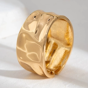 Irregular wide gold alloy bangle bracelet with elegant hammered texture and hinge detail
