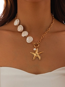 Detail of bohemian shell necklace featuring starfish pendant and golden OT clasp closure