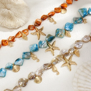 Detail showing shell beaded necklaces with gold sea star and seahorse pendants