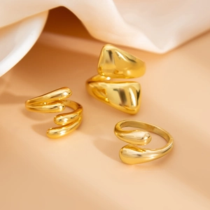 Detailed macro shot of irregular golden rings set with fluid molten liquid metal texture
