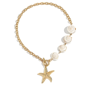 Bohemian gold chain necklace featuring white spiral shells and a starfish pendant with OT clasp