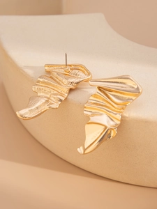 Detail of gold-plated irregular pleated earrings with abstract wave metal texture