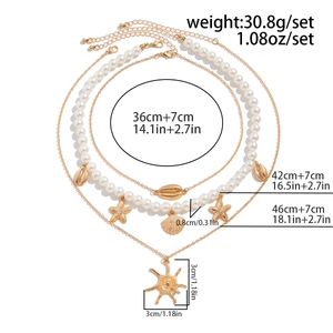 Detailed layered bohemian necklace with starfish and shell pendants showing dimensions