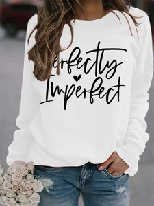 Close-up of Perfectly Imperfect print on white crewneck sweatshirt with heart detail