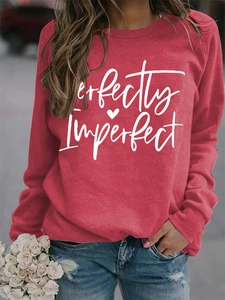 Detail of red crewneck sweatshirt featuring white Perfectly Imperfect letter print