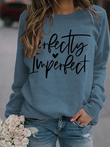 Detail of Perfectly Imperfect text print on navy blue crewneck sweatshirt with heart icon