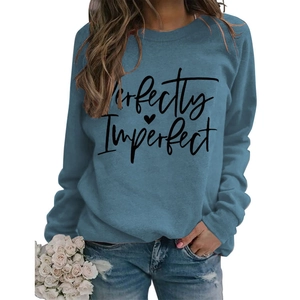 Detail of blue crewneck sweatshirt featuring Perfectly Imperfect printed text and heart