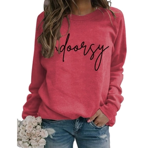Detailed view of Indoorsy slogan print on red crewneck sweatshirt with ribbed collar