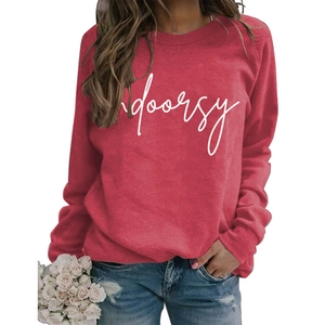 Macro detail of white Indoorsy script print on red long-sleeved sweatshirt fabric