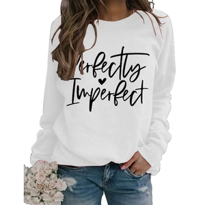 Close-up of Perfectly Imperfect lettering and heart print on a white crewneck sweatshirt
