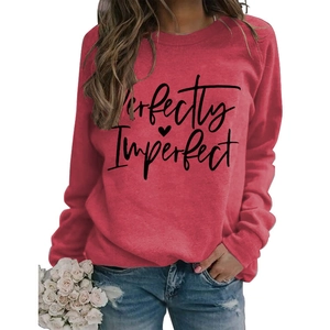 Detail of red crewneck sweatshirt with Perfectly Imperfect print and black heart design