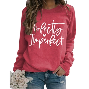 Detail of red crewneck sweatshirt with Perfectly Imperfect print and heart logo