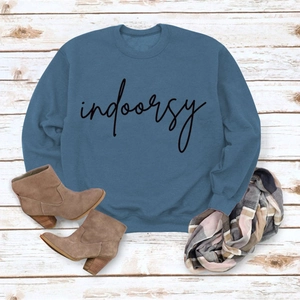 Detail of navy crewneck sweatshirt with indoorsy print on rustic wooden background