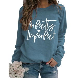 Detail of blue crewneck sweatshirt with white Perfectly Imperfect print and heart logo