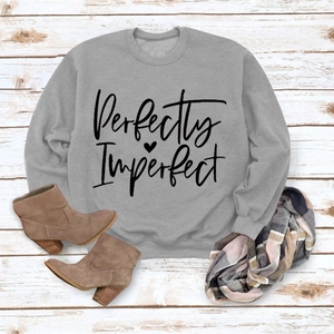 Flat lay of gray Perfectly Imperfect sweatshirt with brown boots and plaid scarf