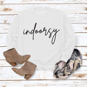 Flat lay of white crewneck sweatshirt with indoorsy print, boots and scarf