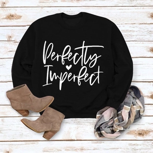Flat lay of black long sleeve sweatshirt with white Perfectly Imperfect letter print