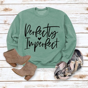 Detail of sage green sweatshirt with Perfectly Imperfect print and ribbed cuffs