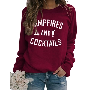 Detail of burgundy sweatshirt featuring campfire and cocktails graphic with casual denim