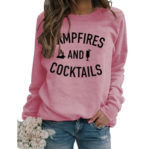 Detailed close-up of pink crewneck sweatshirt with Campfires and Cocktails letter print