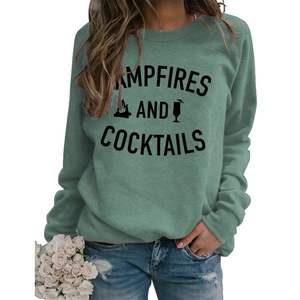 Detail of Campfires and Cocktails slogan print on dark green crewneck sweatshirt