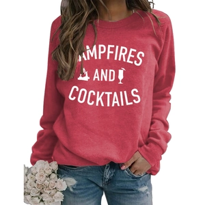 Detail of red crewneck sweatshirt featuring white Campfires and Cocktails graphic print