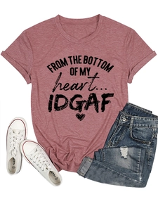 Flat lay of pink cotton T-shirt with heart slogan paired with denim shorts