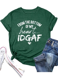 Detailed close-up of dark green t-shirt with white heart graphic and typography print