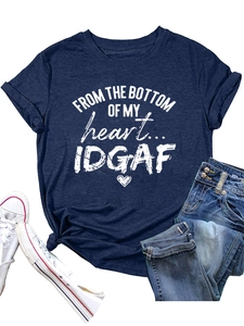 Detail of navy crewneck T-shirt with heart slogan print, jeans and white sneakers