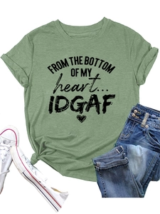 Detail view of grass green cotton T-shirt with black graphic slogan and heart print