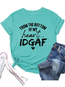Flat lay of lake blue t-shirt featuring FROM THE BOTTOM printed text with denim and shoes