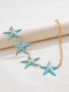 Detail of golden metal waist chain with four light blue starfish charms on a beige stand