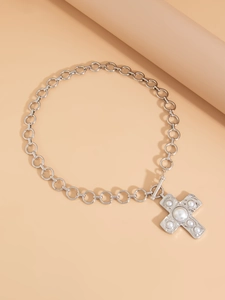 Detail of silver chain necklace with a pearl-inlaid cross pendant and OT buckle closure