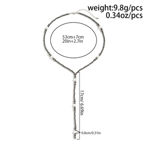 Detail view of Y-shaped beaded necklace with sizing specs and pearl tassel