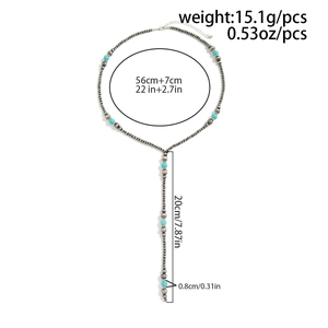 Detailed view of silver beaded Y-necklace showing length and turquoise stone accents
