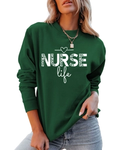 Close-up of NURSE Life leopard print graphic on dark green crewneck sweatshirt fabric