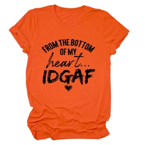 Close-up of orange crew neck T-shirt featuring black heart and letter graphic print