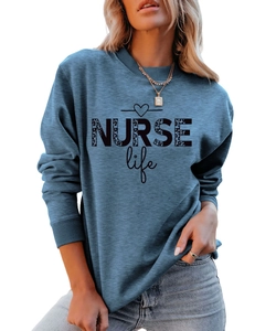 Close-up of NURSE Life print with leopard pattern on blue crewneck sweatshirt fabric
